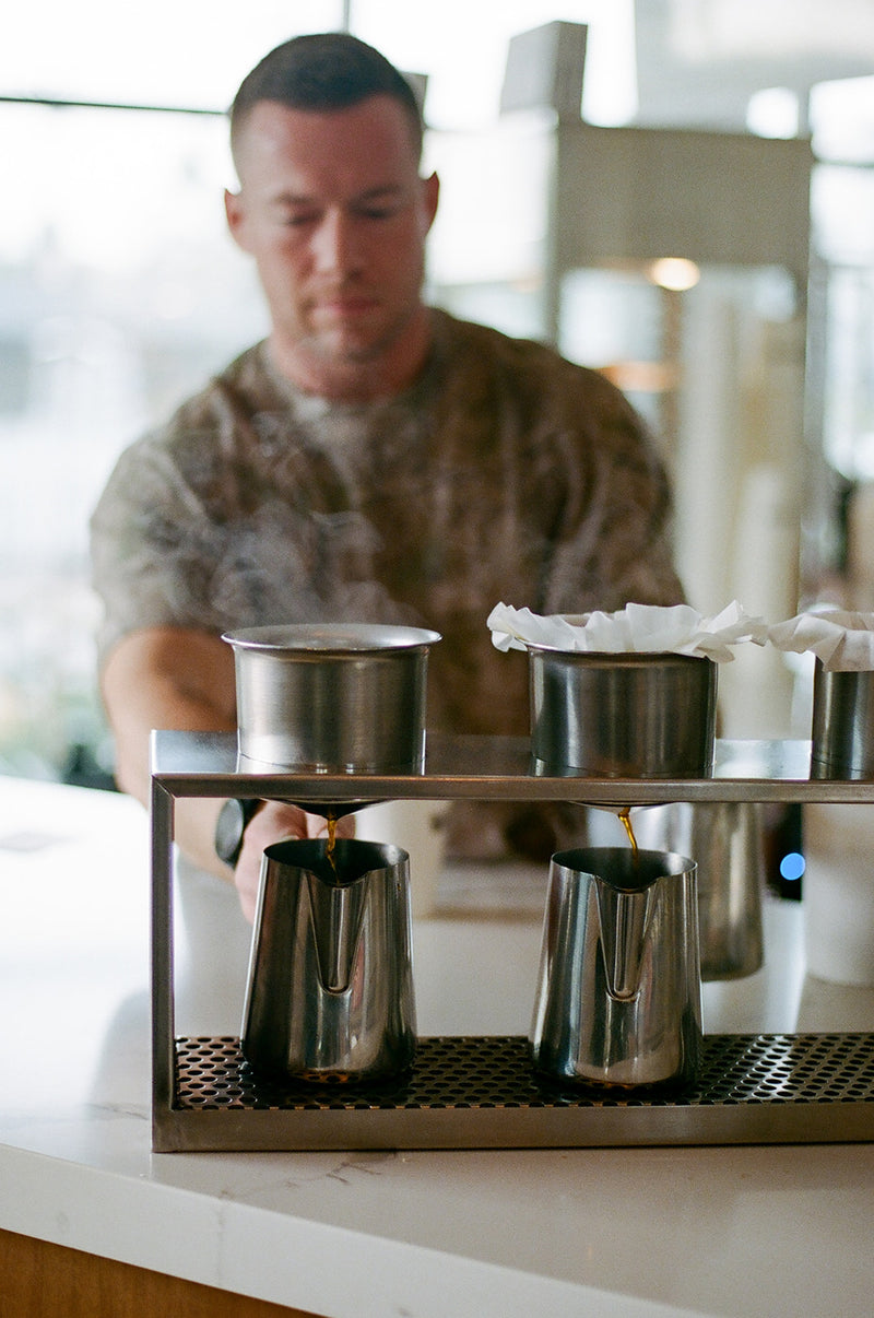 Hand brews dripping into pitchers at the bar