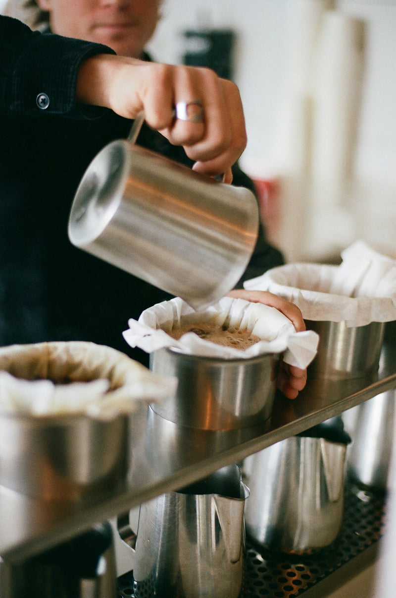 Pouring water over a hand brew at the bar